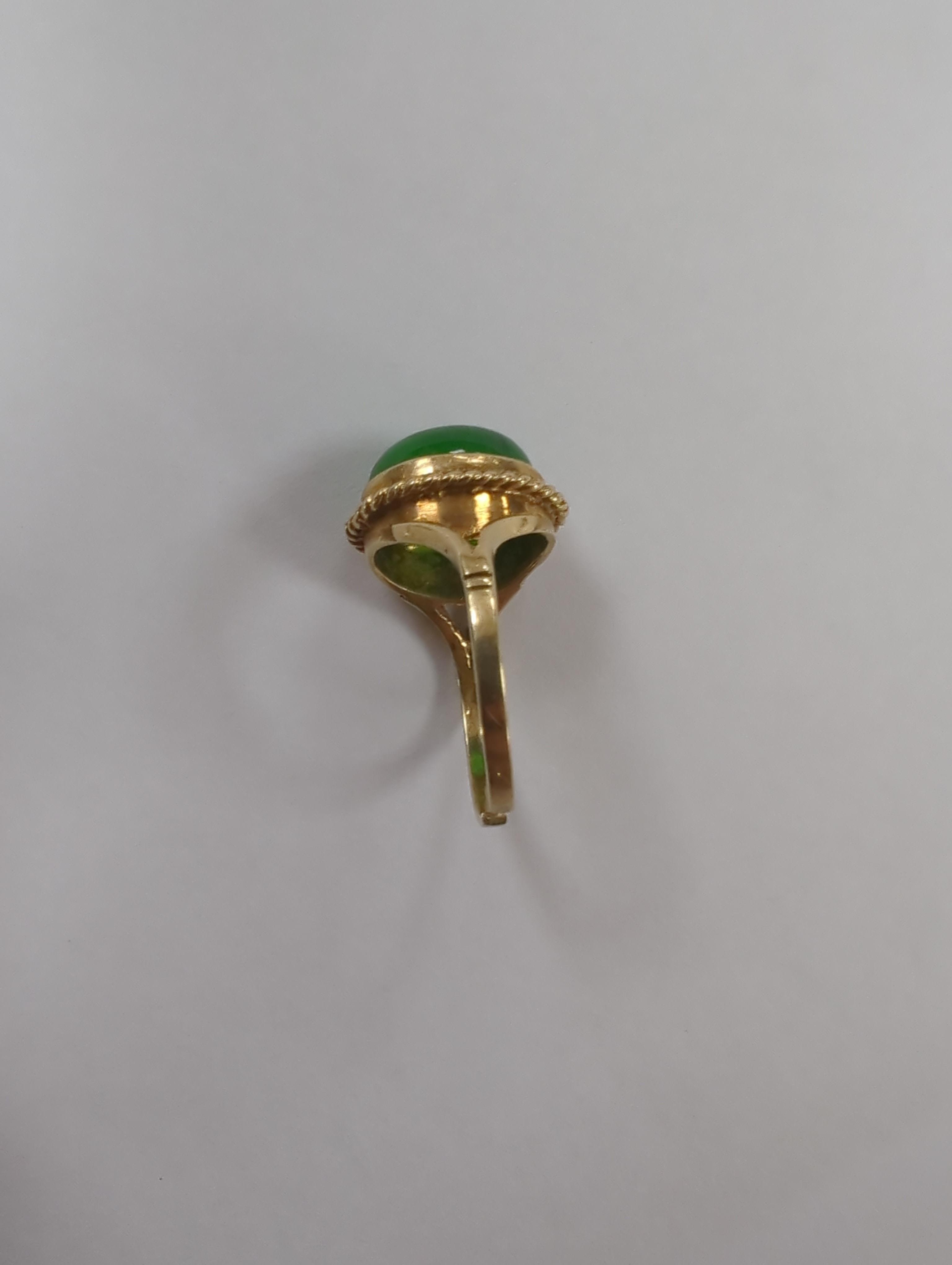 A 9ct gold and cabochon jade set oval ring (shank cut), gross weight 4.3 grams.